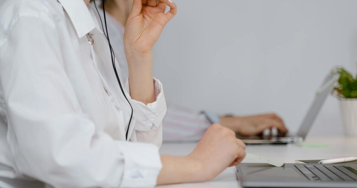 A Woman Talking on a Headset while Working